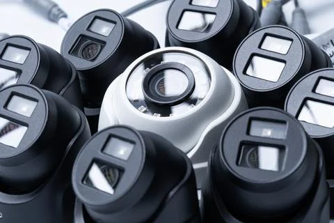 Close-up of a white security camera against the background of other cameras Stock Photos