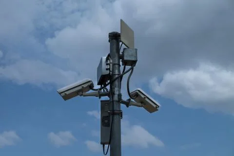 Close up of white security camera and white sky Stock Photos