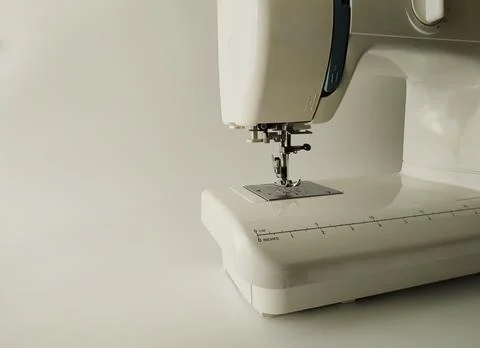 Close-up of a white sewing machine on a white background Stock Photos
