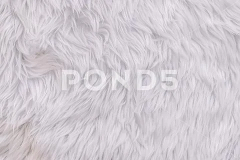 Close up white shaggy artificial fur texture or carpet for background. Stock Photos