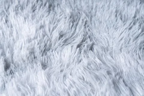 Close up white shaggy artificial fur texture or carpet for background. Stock Photos