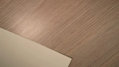Close up of white sheet of paper appearing in shot and girl's hands fold it. Stock Footage 124243805