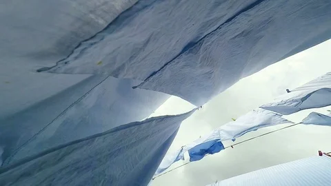 Close-up of white sheets waving in the wind outdoor. 動画素材 90134563