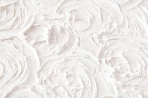 Close-up of white shell patterns on sandy beach surface Фото