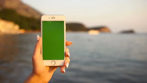 Close up of the white smart phone with green screen being holded in a female Stock Footage 85646057