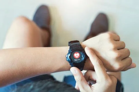 Close up white smart watch with icon Heart rate, healthcare concept. Stock Photos