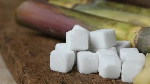 Close up of white sugar cubes. sugar cube on the wooden background 動画素材 345068438