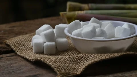 Close up of white sugar cubes. sugar cube on the wooden background 動画素材 345069241