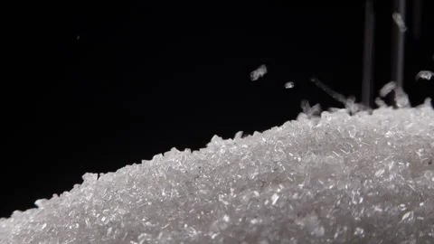 Close up of white sugar falling on sugar mountain on black background Stock Footage 254103189