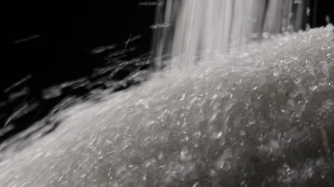 Close up of white sugar falling on sugar mountain on black background Stock Footage 254103307