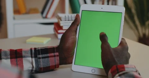 Close up of the white tablet device with chroma key screen in the hands of the Video stock 104224700