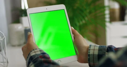 Close up of the white tablet device with chroma key screen in hands of the Stock-Footage 104978575