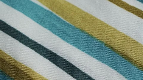 Close-up of white textile fabric with blue and green vertical stripes, showing Stock Footage 330108562