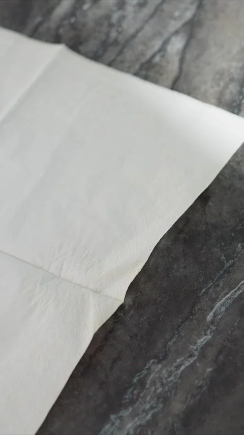Close up white textured folded tissue on gray marble background with soft Stock Footage 345732573