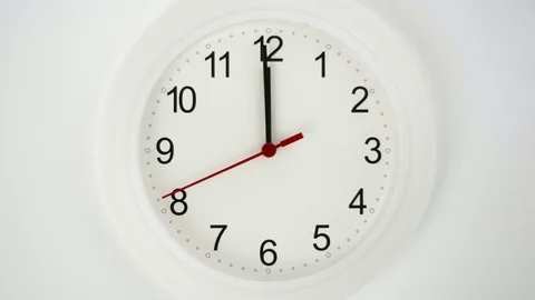 Close up of a white ticking clock, midnight Stock Footage
