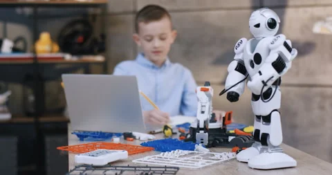 Close up of the white toy robot being on the desk in front of the camera, and Stock Footage 135841274