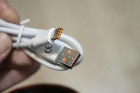 Close-up of a white USB cable with a unique port, showcasing modern technology Stock Photos