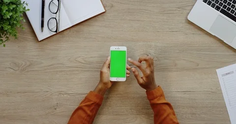 Close up of the white vertical smartphone being on the light wooden desk of the Stock Footage 96005518