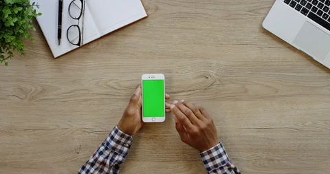 Close up of the white vertical smartphone being on the light wooden desk of the Stock-Footage 96007662
