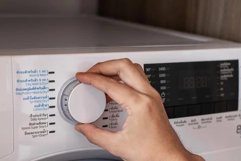 Close-Up white washing machine control panel In laundry room. Stock Photos