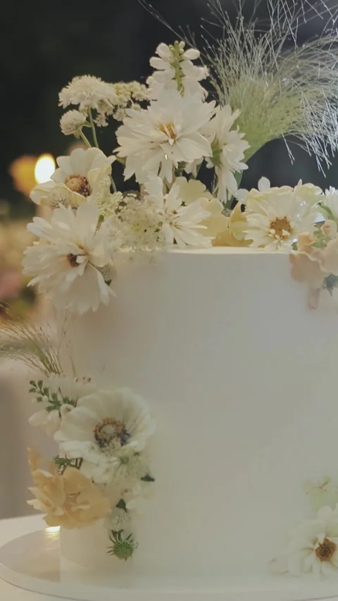 Close-up of a white wedding cake decorated with flowers, perfect for any joyful Stock Footage 307844798