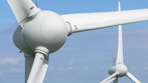 Close up of white wind turbine blades against a clear blue sky Stock Footage 344276151