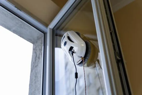 Close up of a White Window Cleaning Robot Working on Glass Stock Photos