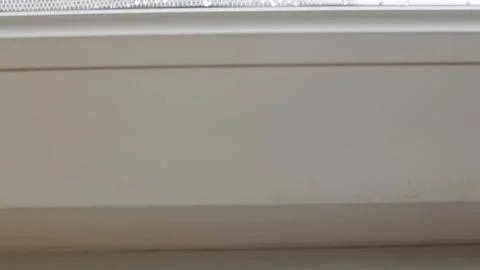 Close-up of white window frame with a window sill, which spreads a puddle Vídeo Stock 289754052