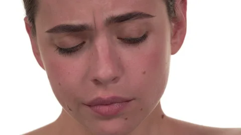 Close up of a white woman's face. Looking at camera and then down. Being cheeky Stock-Footage 197414456