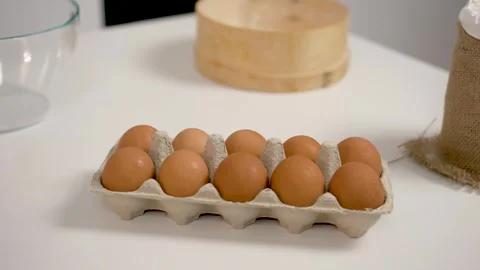 Close up. Whole eggs lies in container. Chicken brown fresh raw eggs in paper Stock Footage 255283886