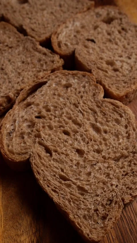 Close-Up of Wholegrain Bread Slices Showing Rustic Crumb Stock Footage 344104691