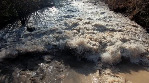 Close up wide brown chaotic Alpine river after season rain Stock Footage 121679810