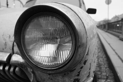 Close wide low angle view of an old soviet vintage muscle car headlight Photos