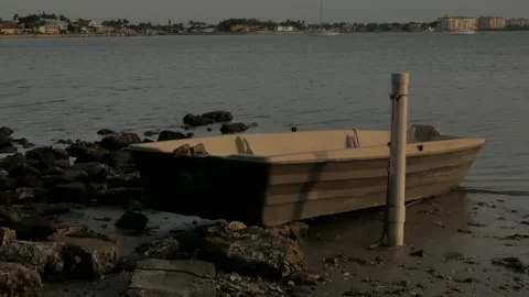 Close up Wide View out to Boca Ciega Bay over a small brown and white rowboat. Stock Footage 269994490