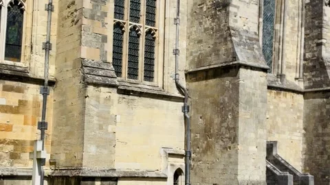 Close up of Winchester Cathedral Gothic buttresses and stained glass windows in Stock Footage 340601668