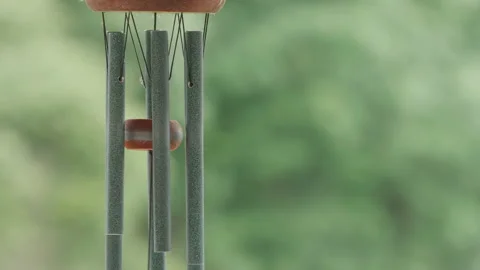Close up of wind chimes gently swaying in the breeze - audio. 4K locked tripod Stock Footage 156709667