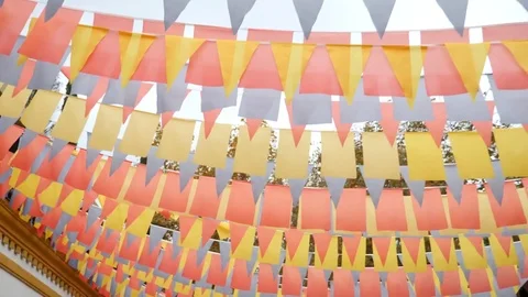 Close-up of wind flaps garlands of colorful flags against blue sky. 4K copy Stock Footage 81573964