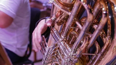 Close-up of wind instruments. The musician's fingers press on the valves of the 库存影片 164143314