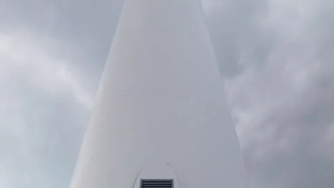 Close-Up of Wind Turbine Base with Overcast Skies Stock Footage 333626899