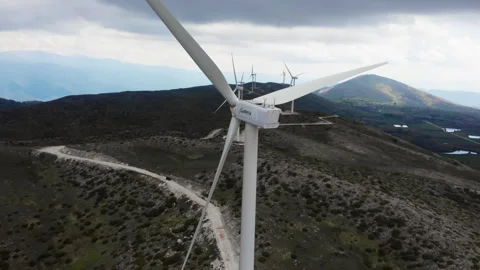 Close-Up of Wind Turbine Blades Over Rolling Hills Stock Footage 333627010