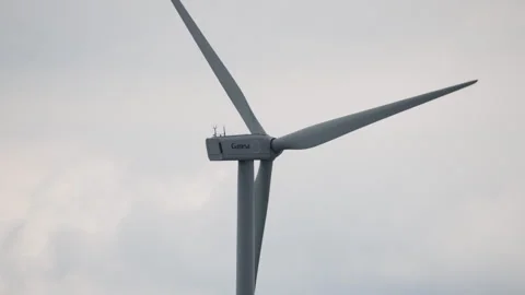 Close-Up of Wind Turbine Blades Rotating in Overcast Conditions Stock Footage 333627038