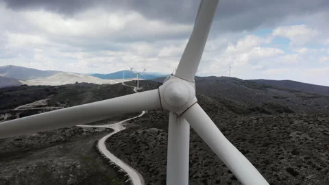 Close-Up of Wind Turbine Blades on Rugged Hillside Stock Footage 333627282