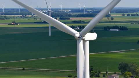 Close up of wind turbine blades spinning over a rural landscape 库存影片 343326801