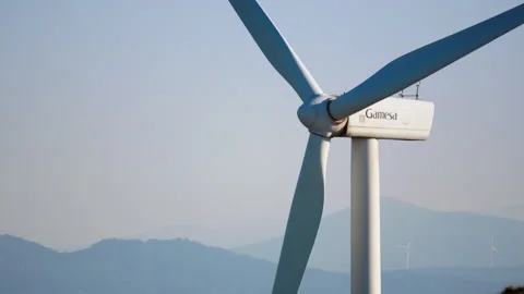 Close-Up of Wind Turbine with Distant Hills in Background Stock Footage 334552051
