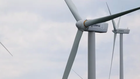 Close-Up of Wind Turbines Rotating Against Cloudy Skies Stock Footage 333626873