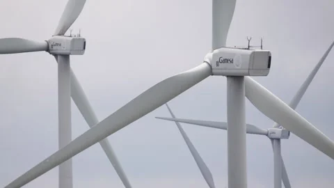 Close-Up of Wind Turbines Rotating Against Cloudy Skies on Vermio Mountain Stock Footage 333627094