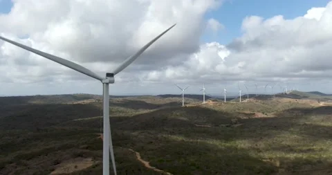 Close up of windmill with Many more wind turbines generating electricity Stock Footage 160945095