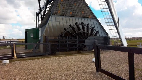 Close up of a windmill with water wheel Stock Footage