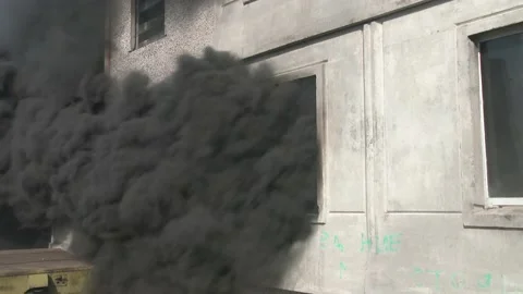 Close up of window of an apartment building from which smoke comes out. A house  Video stock 148290159