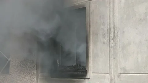 Close up of window of an apartment building from which smoke comes out. A house  Stock Footage 148290297